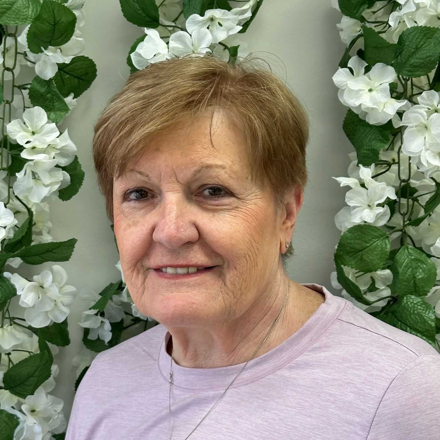 Portrait of Cathy, a professional stylist at Zootcuts, showcasing their expertise and style.