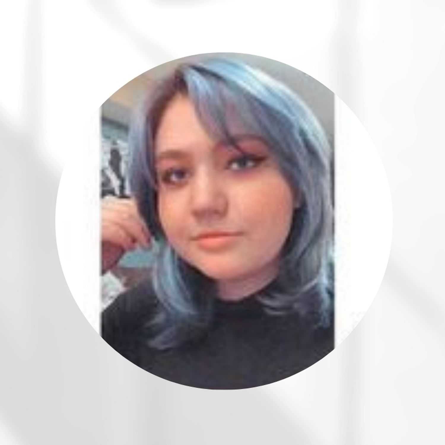 Portrait of Kylie, a professional stylist at Zootcuts, showcasing their expertise and style.