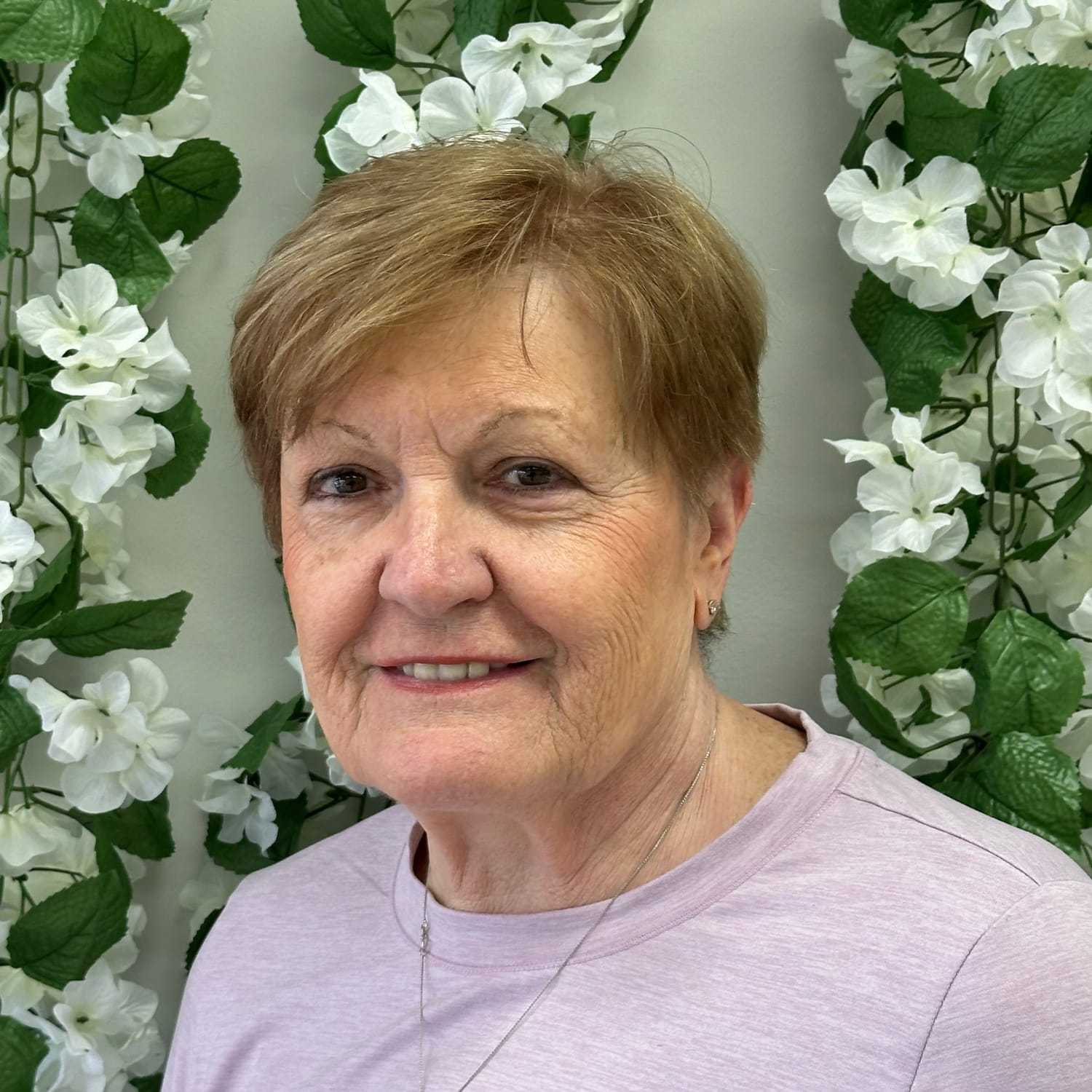Portrait of Cathy, a professional stylist at Zootcuts, showcasing their expertise and style.
